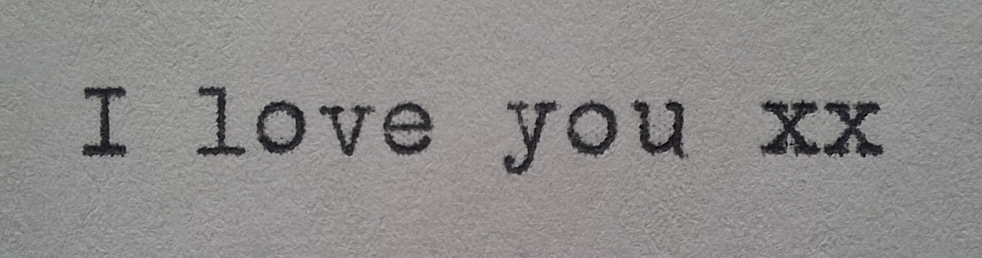The words 'I love you' written on a typewriter
